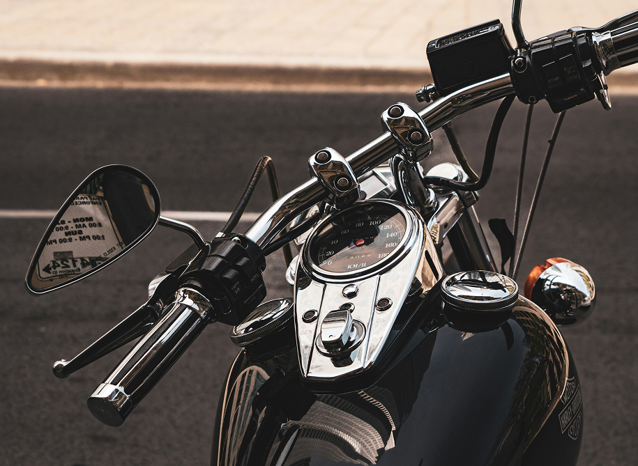 Close-up of a motorcycle handlebar with controls and grips