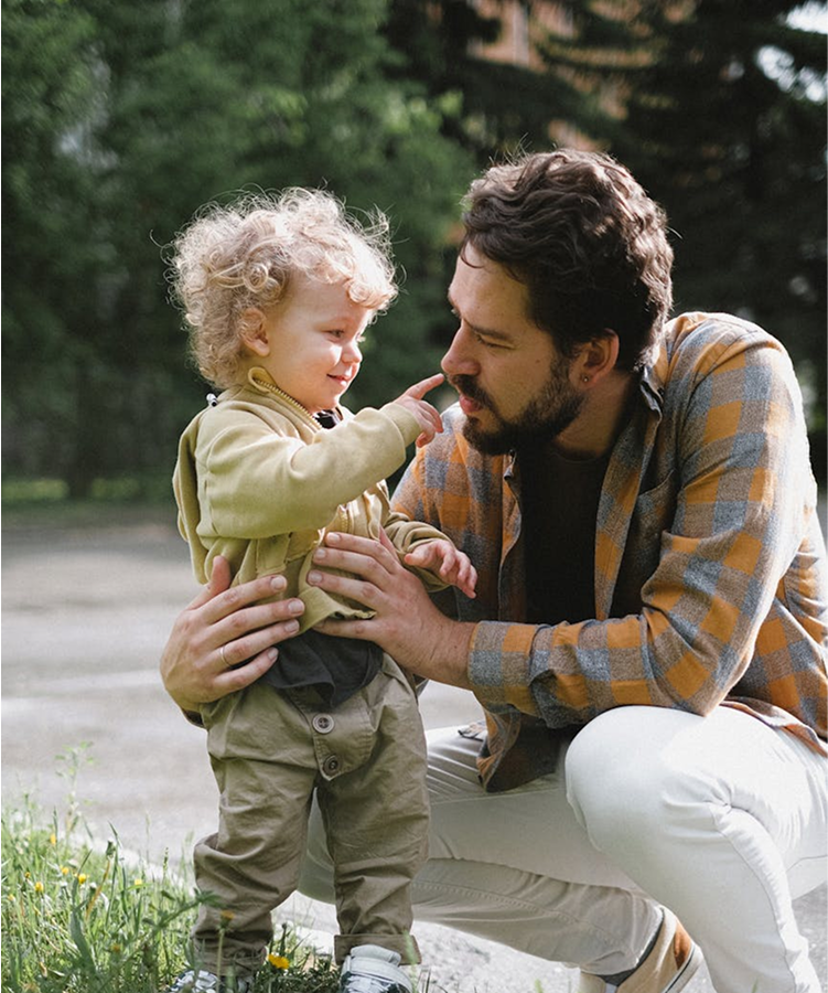 Dad bonding with his child in the backyard, enjoying outdoor games
