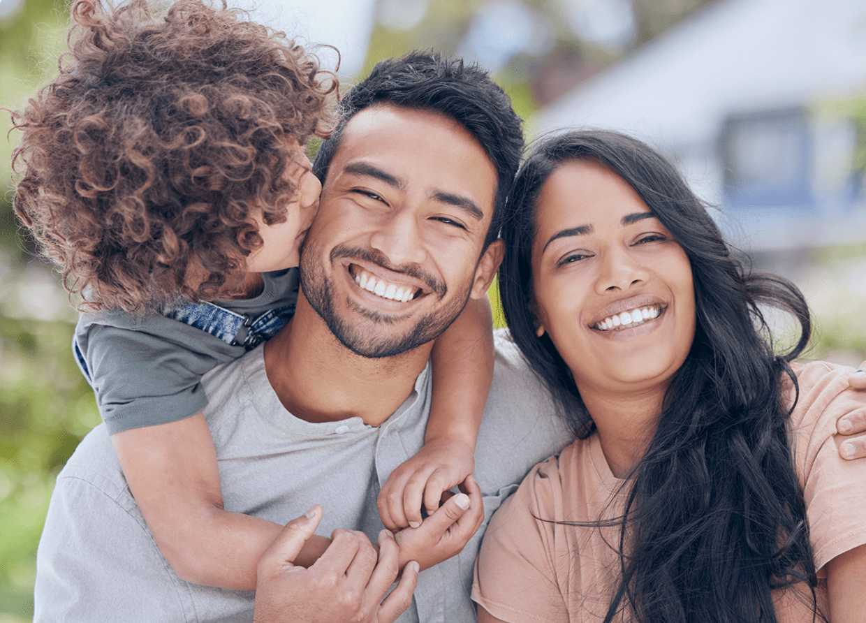 Happy parents and children laughing and spending time together in a warm, loving environment