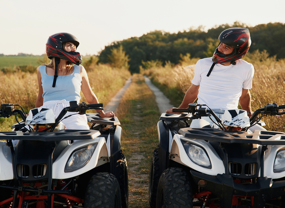 Male and female bikers riding motorcycles together on a scenic road