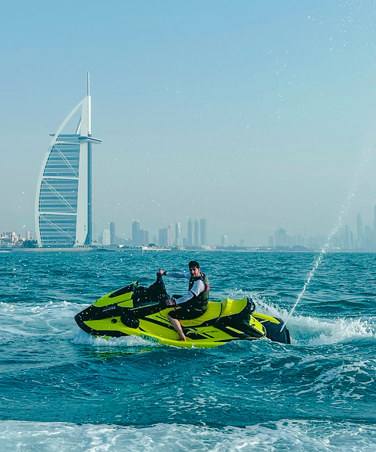 Small boat floating on the vast ocean with clear blue water and sky