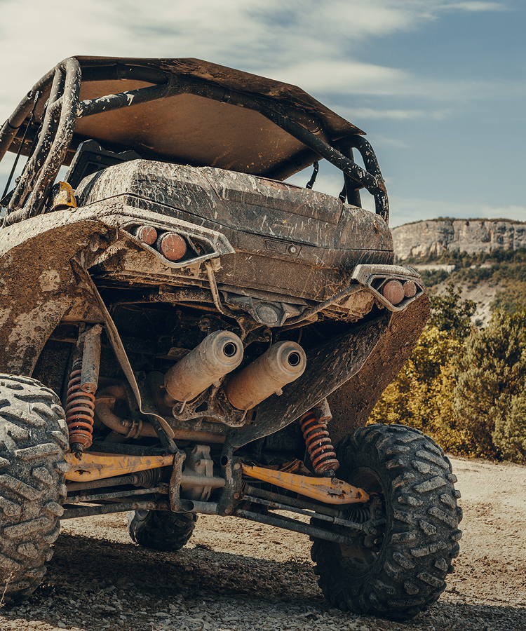 Off-road vehicle covered in mud after a rugged outdoor adventure
