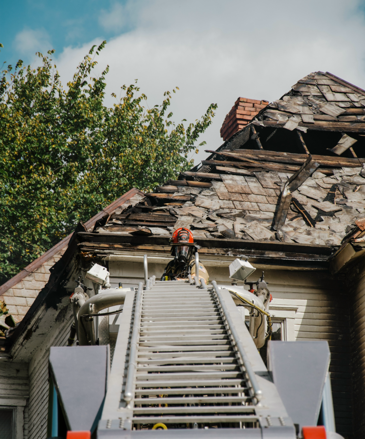 Construction workers rebuilding and repairing a house exterior under renovation
