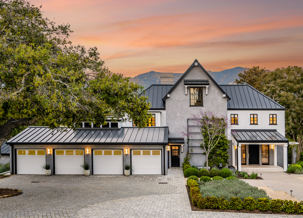 Luxury home exterior with four-car garage and modern architectural design